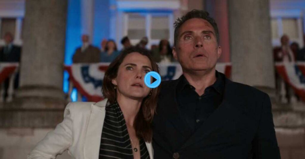 Keri Russell and Rufus Sewell as Kate and Hal Wyler, looking up at the sky with concerned expressions at an outdoor event in a still from the series The Diplomat.