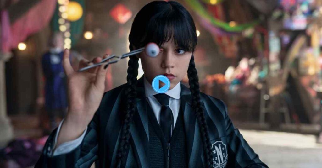 Jenna Ortega as Wednesday Addams in her Nevermore Academy uniform, holding an eyeball with tweezers, with a carnival-like background behind her.