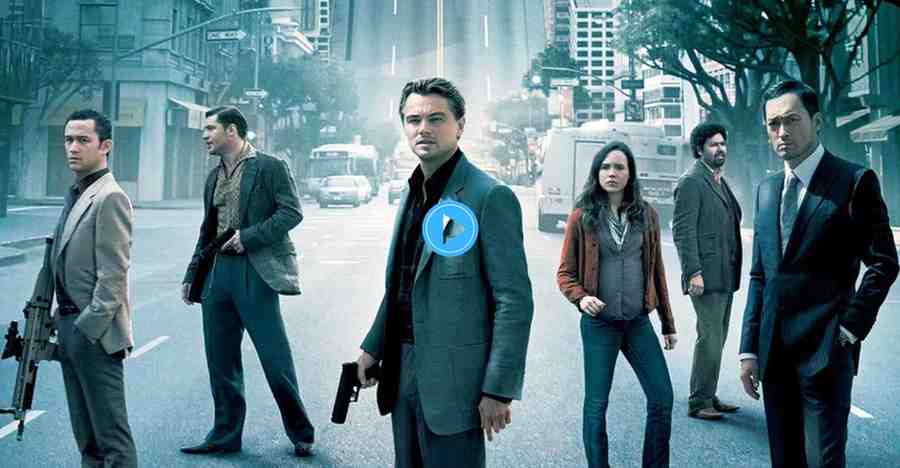 The main poster for the film Inception featuring the six lead cast members, including Leonardo DiCaprio (holding a pistol in the center), Joseph Gordon-Levitt, and Elliot Page, all standing on a city street.